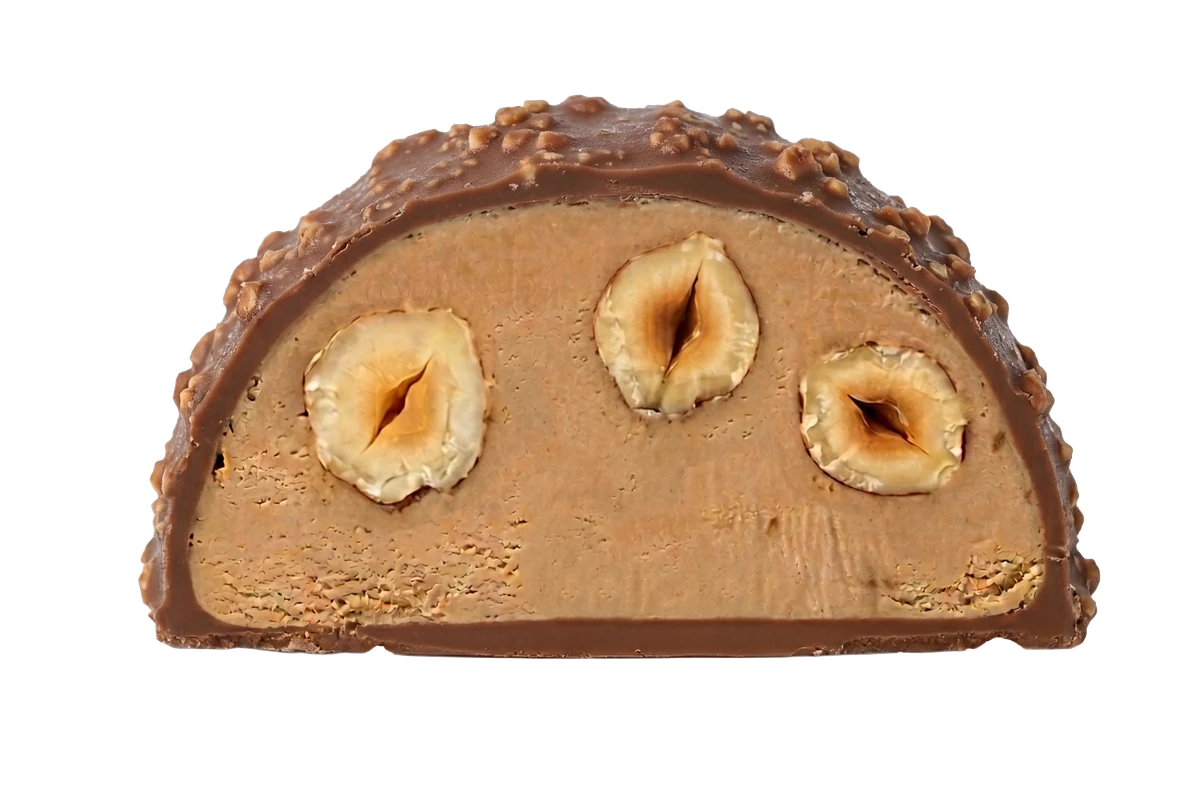 Hazelnut bonbon cut in half showing whole Piemonte hazelnuts inside