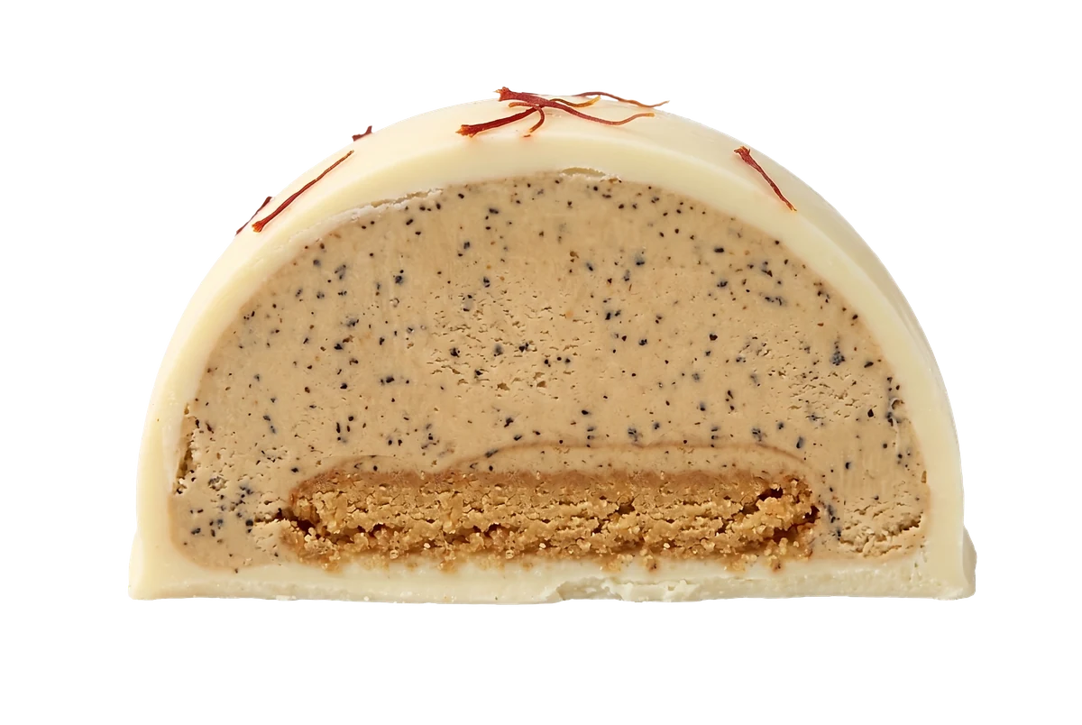 Karak bonbon cut in half revealing the karak tea gelato and digestive biscuit layer