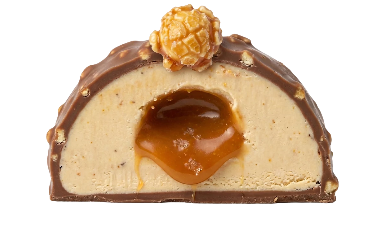 Salted Caramel and Popcorn bonbon cut in half revealing a molten caramel center